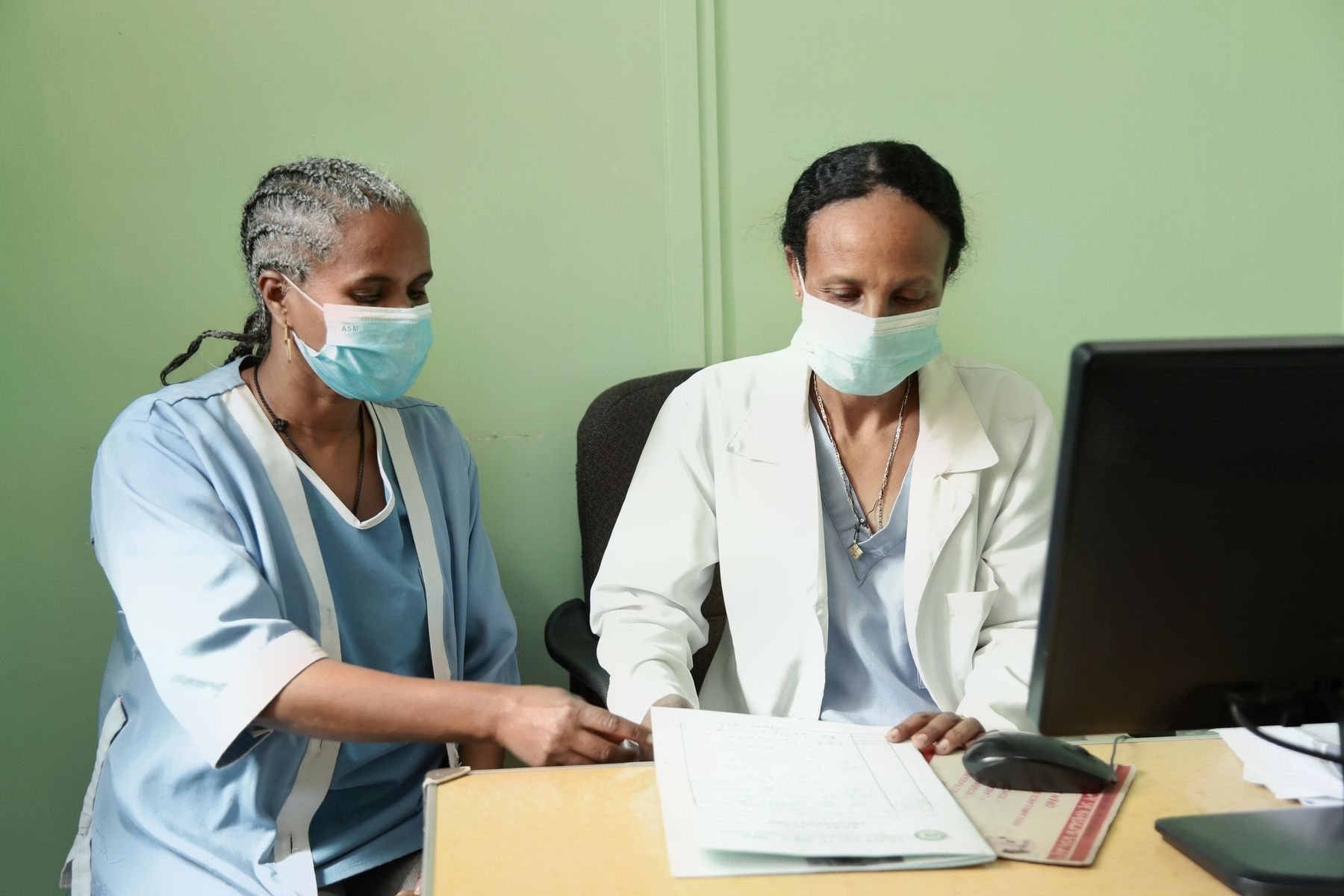 Two doctors reviewing a patient's records together