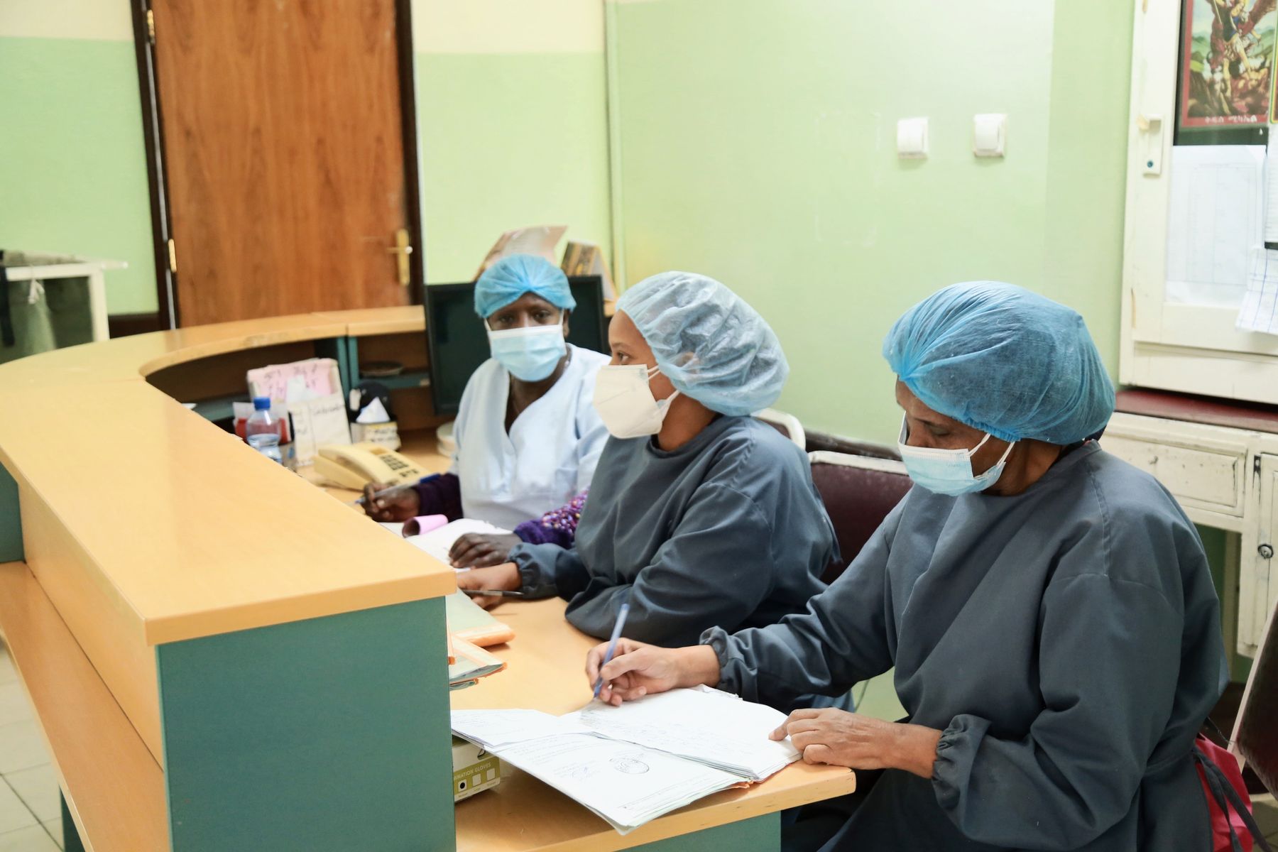 Reception staff registering patients at the Yordanos Hospital front desk