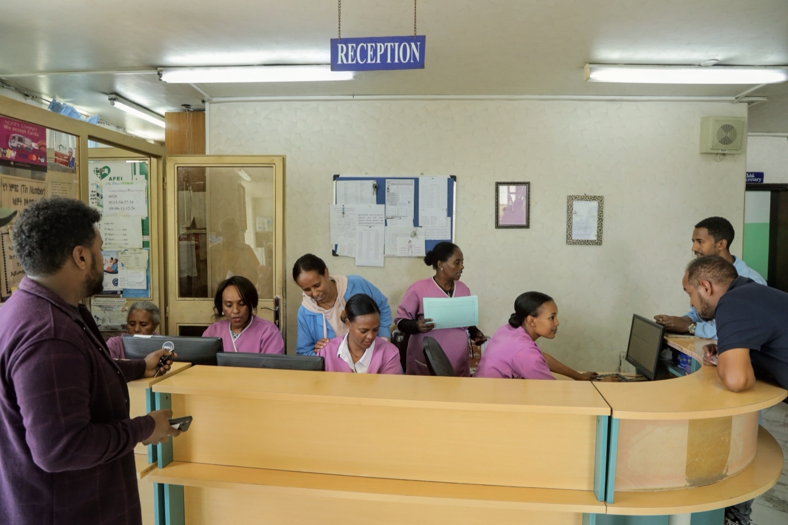 The reception desk at Yordanos Hospital with staff assisting visitors